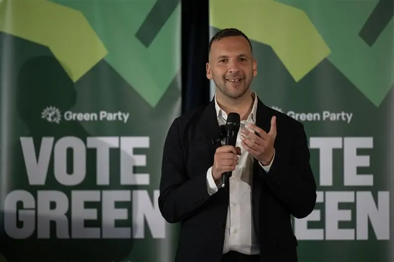 Zack Polanski speaking at the launch of the Green Party’s local election campaign in Deptford, in front of two green “Vote Green” banners